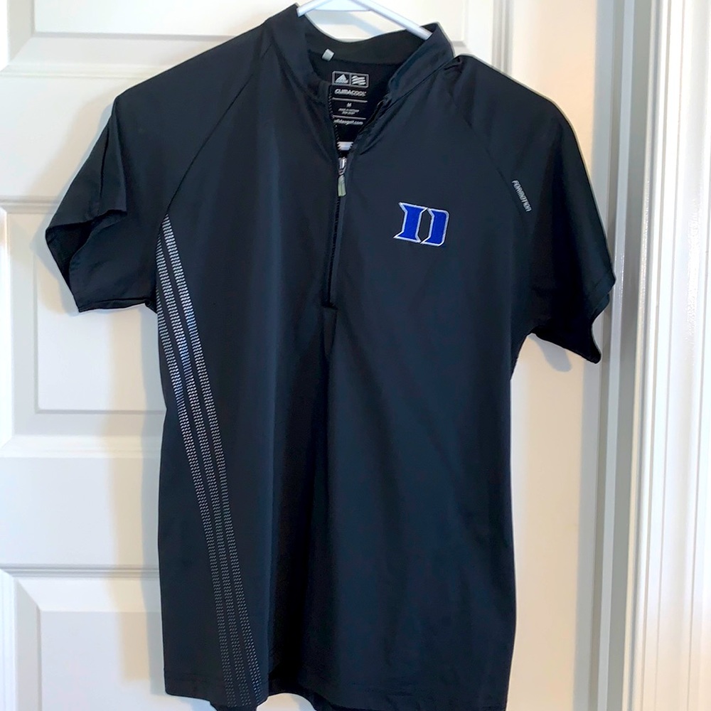 Adidas woman’s black golf shirt with Duke Logo.